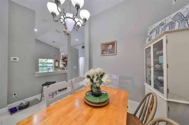 tiled dining space featuring vaulted ceiling and a notable chandelier