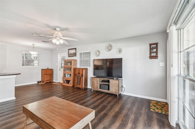 living room featuring ceiling fan and dark hardwood / wood-style flooring