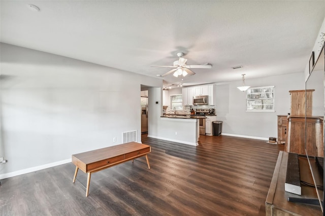 dining space featuring dark wood-type flooring and ceiling fan