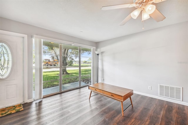 interior space featuring ceiling fan and dark hardwood / wood-style flooring