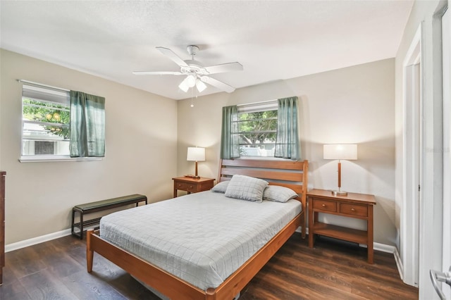 bedroom with dark wood-type flooring and ceiling fan