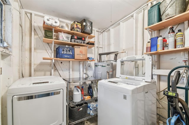 laundry room with electric water heater and washing machine and dryer