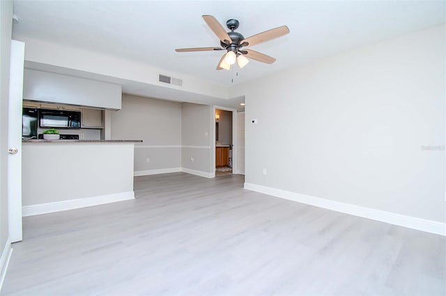 spare room with light hardwood / wood-style flooring and ceiling fan