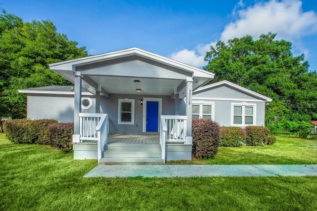 bungalow-style house with a porch and a front yard