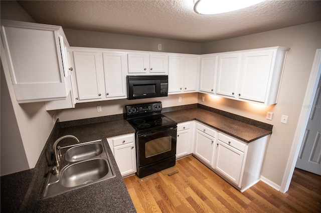 kitchen with light wood-type flooring, a textured ceiling, black appliances, sink, and white cabinets