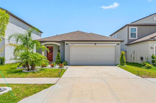 view of front facade with a garage and a front yard