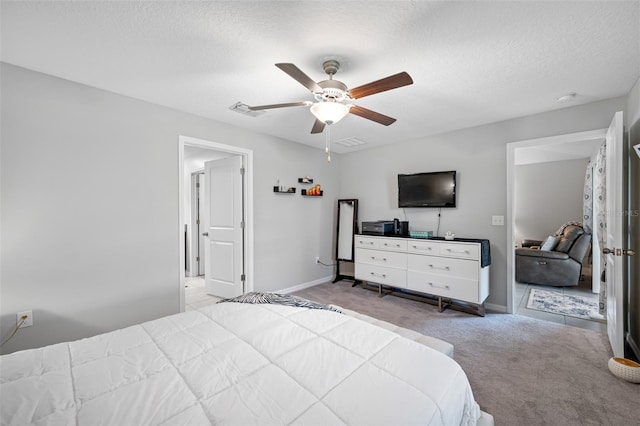 carpeted bedroom with a textured ceiling and ceiling fan