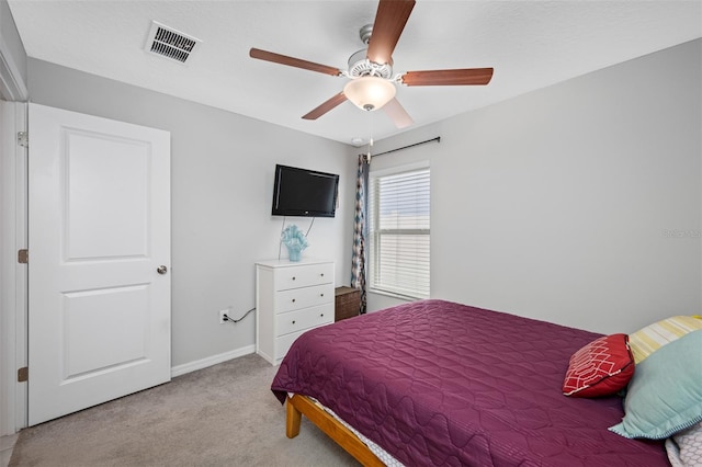 bedroom with ceiling fan and light carpet