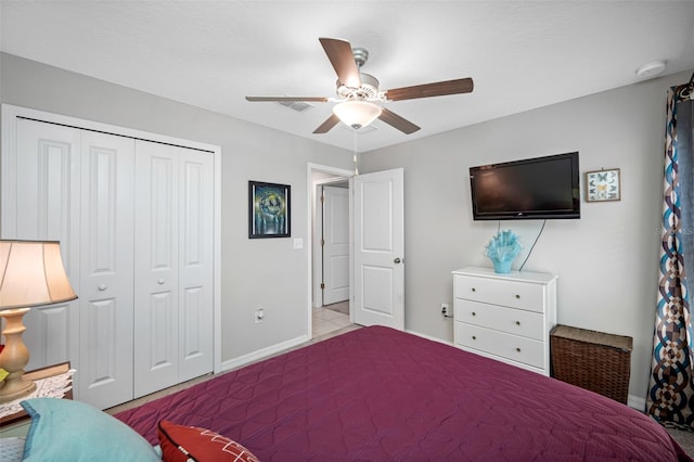 bedroom with a closet, ceiling fan, and light tile patterned floors