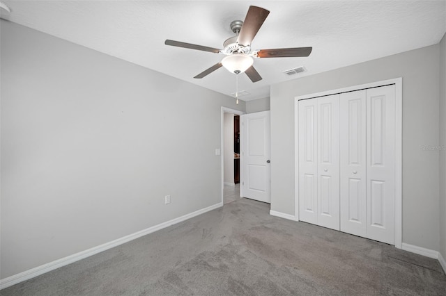 unfurnished bedroom featuring a closet, ceiling fan, and carpet flooring