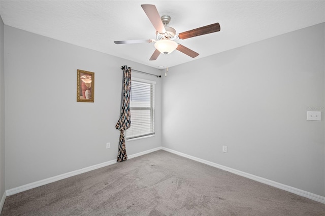 unfurnished room with ceiling fan and carpet floors