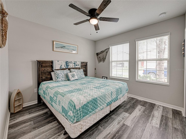 bedroom with a textured ceiling, hardwood / wood-style flooring, and ceiling fan