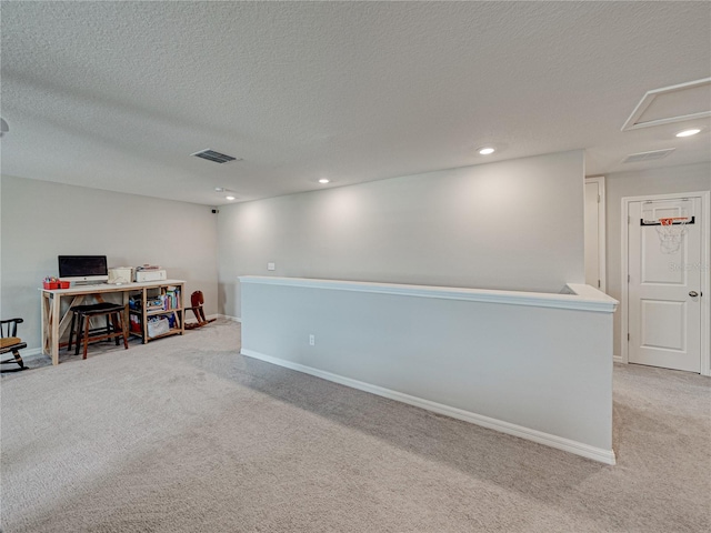 interior space featuring carpet flooring and a textured ceiling