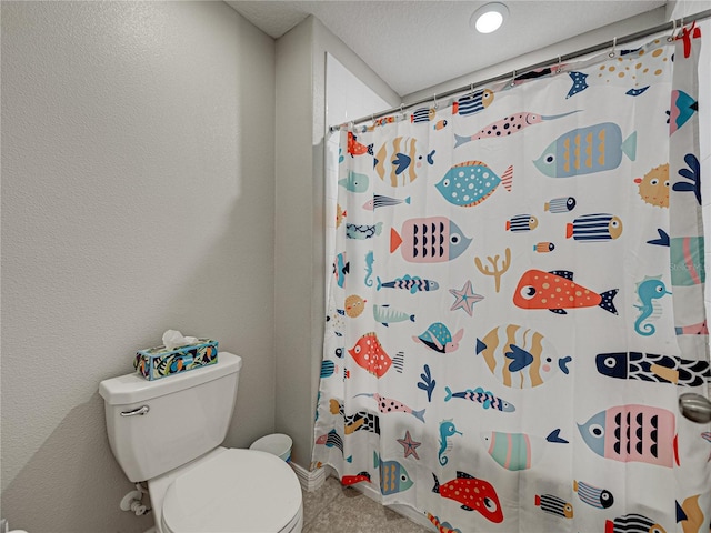 bathroom with a shower with curtain and toilet