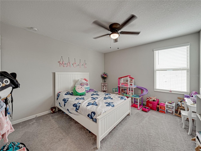 bedroom featuring a textured ceiling, carpet, and ceiling fan