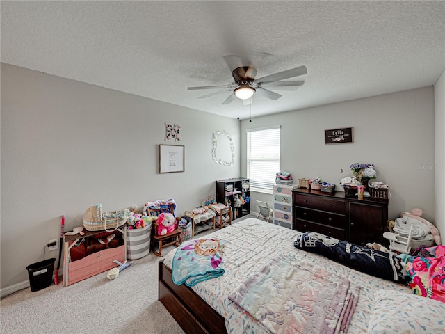 carpeted bedroom featuring a textured ceiling and ceiling fan