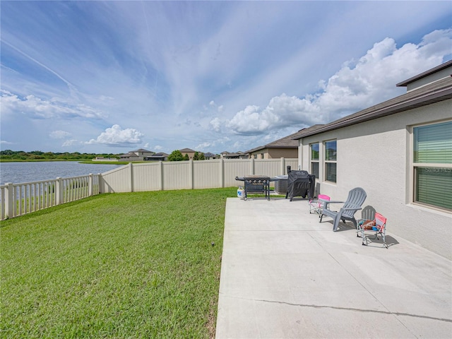 view of yard featuring a water view and a patio