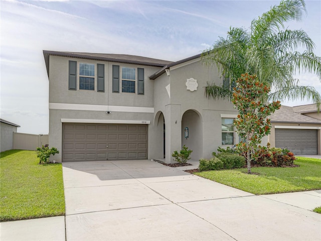 view of front of house featuring a garage and a front lawn