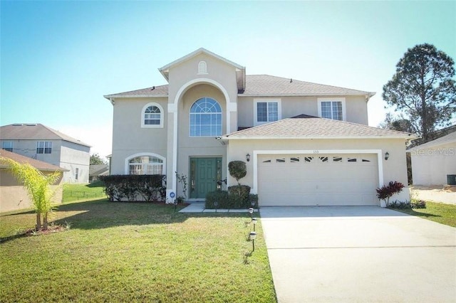 view of front of home with a garage and a front lawn