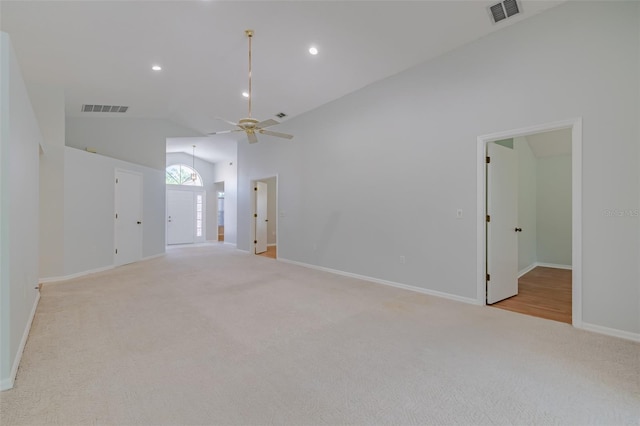 carpeted empty room featuring vaulted ceiling and ceiling fan