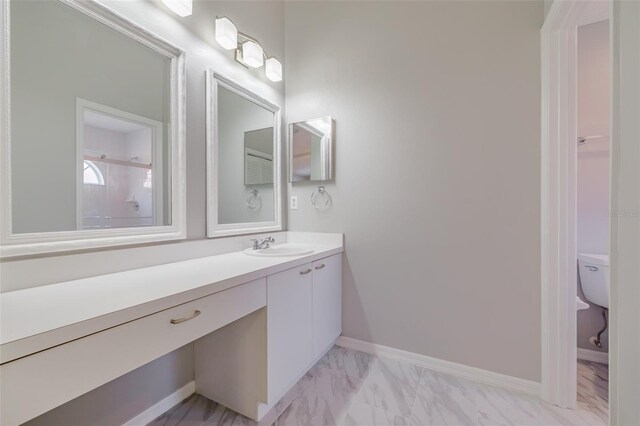 bathroom with vanity, toilet, and walk in shower