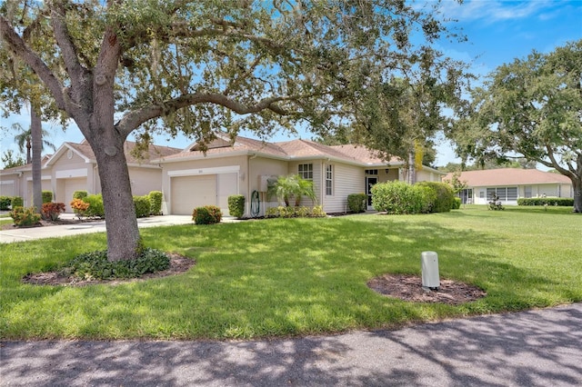 single story home featuring a front yard and a garage