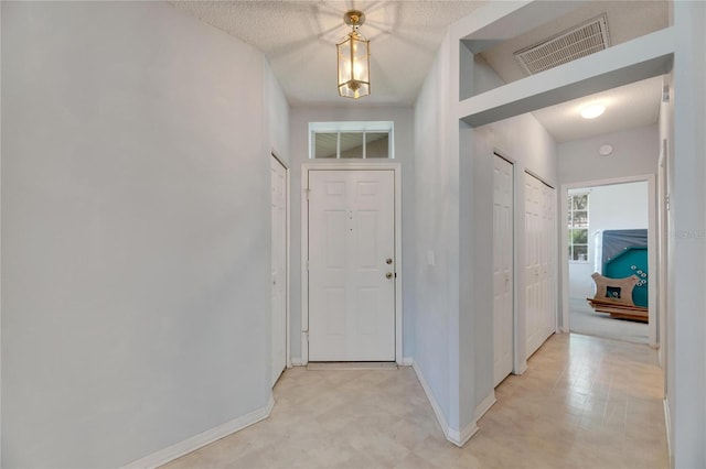 foyer featuring a textured ceiling