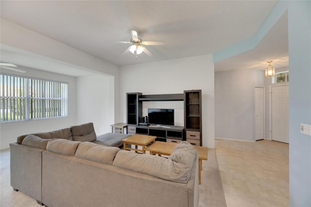 living room featuring a textured ceiling and ceiling fan