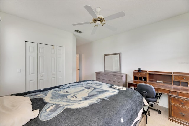 bedroom featuring a closet, ceiling fan, and light carpet