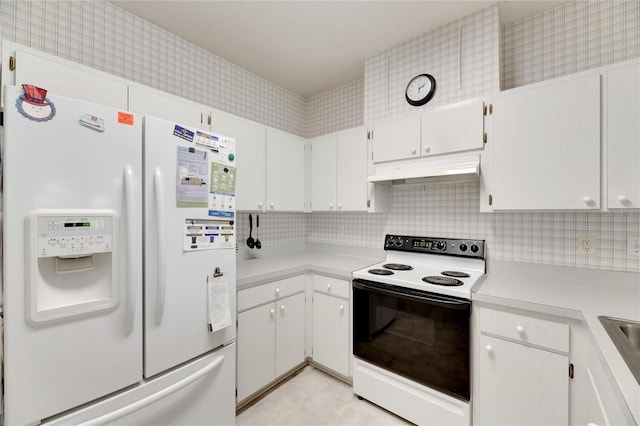 kitchen featuring white cabinetry, white appliances, and backsplash