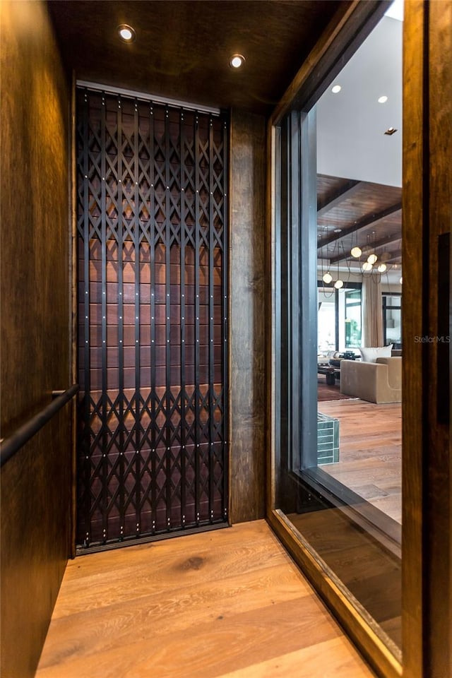 wine room with hardwood / wood-style floors