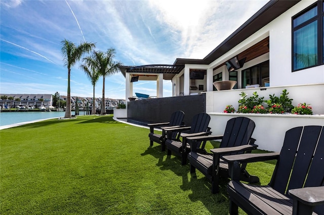 view of yard featuring a water view and a pergola