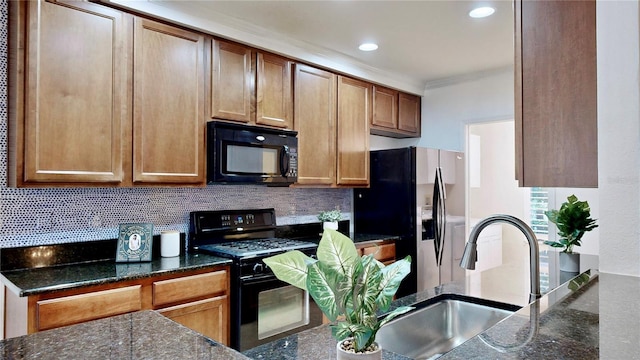 kitchen featuring crown molding, black appliances, backsplash, and sink