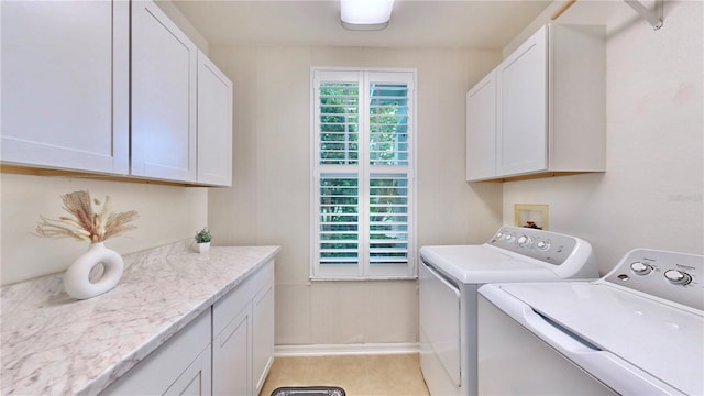 washroom with a healthy amount of sunlight, cabinets, and separate washer and dryer