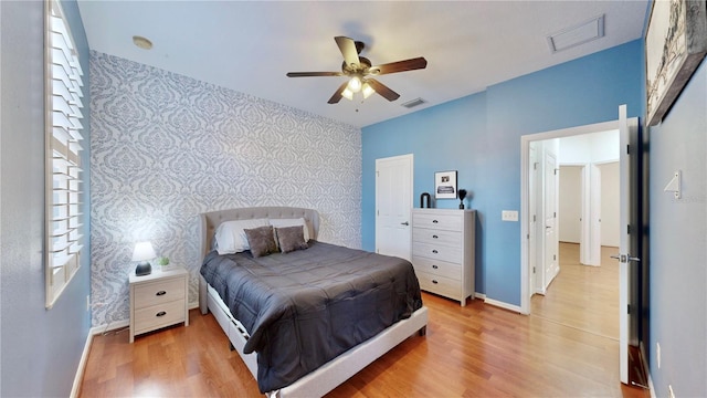 bedroom with light wood-type flooring and ceiling fan