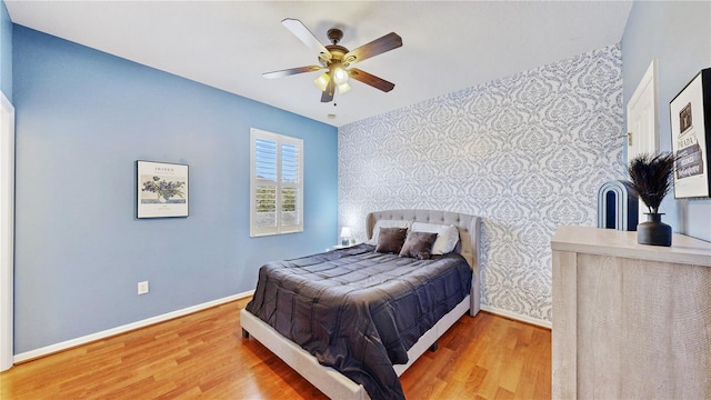 bedroom with wood-type flooring and ceiling fan