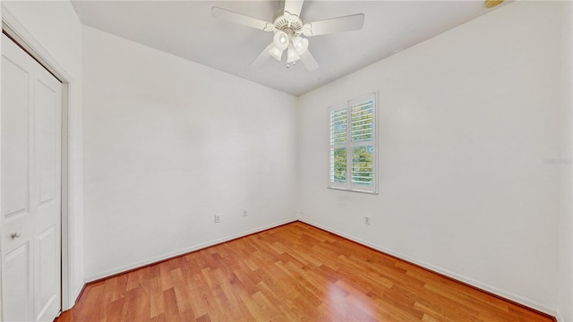 unfurnished bedroom featuring ceiling fan, a closet, and light wood-type flooring