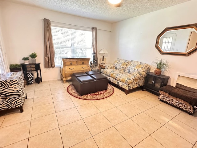 living room with tile patterned floors and a textured ceiling