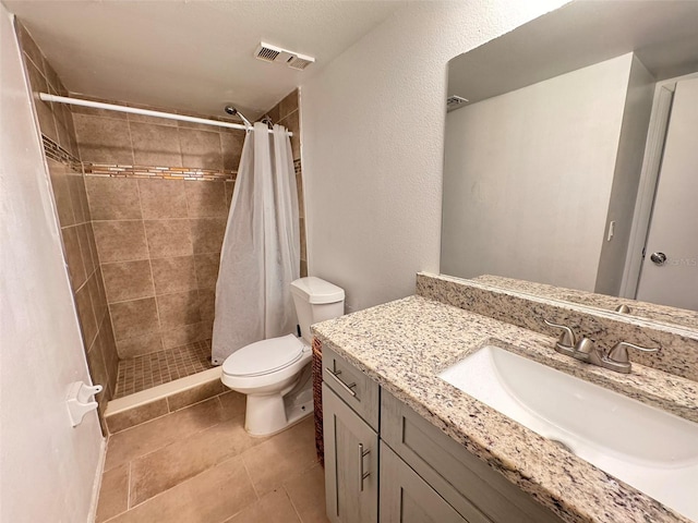 bathroom featuring curtained shower, tile patterned floors, toilet, and vanity