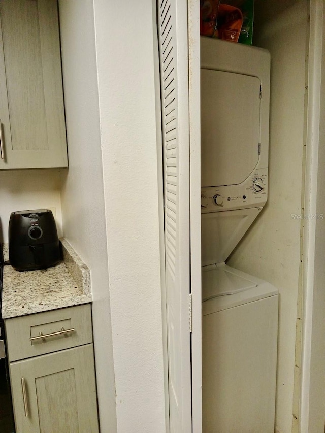 laundry area featuring stacked washing maching and dryer