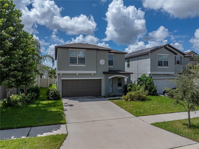 front of property with a front yard and a garage