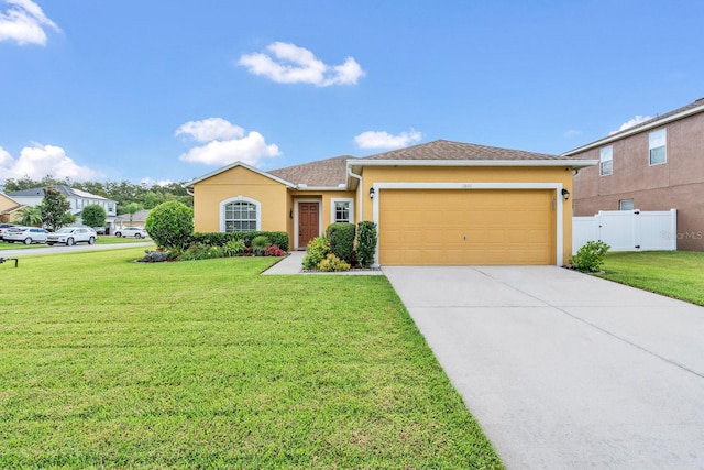 view of front of home with a garage and a front lawn