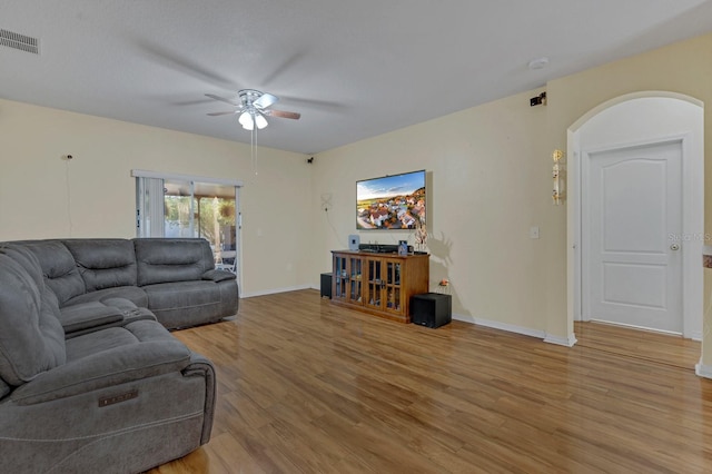 living room with ceiling fan and light hardwood / wood-style flooring