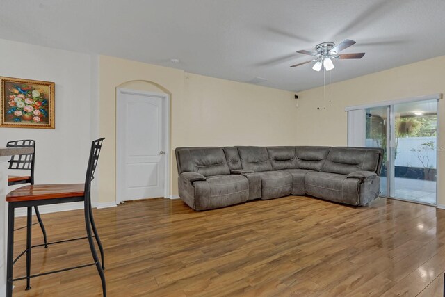 living room featuring ceiling fan and wood-type flooring