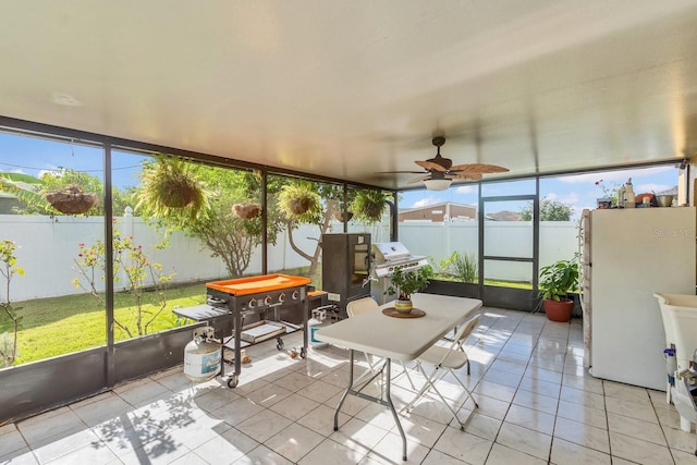 sunroom / solarium featuring a wealth of natural light and ceiling fan