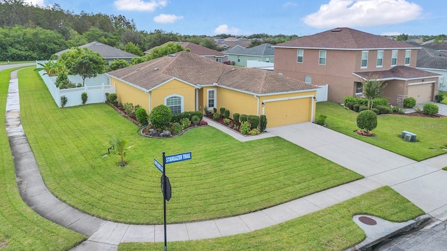 view of front of property with a garage and a front yard