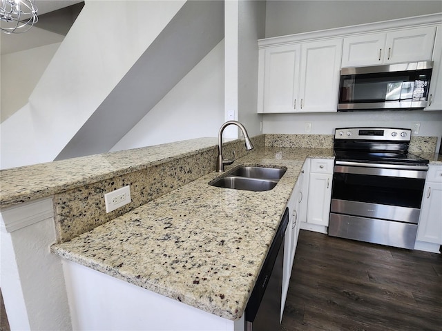 kitchen with dark hardwood / wood-style floors, appliances with stainless steel finishes, sink, light stone counters, and white cabinets