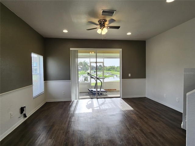 unfurnished room with ceiling fan and dark hardwood / wood-style flooring