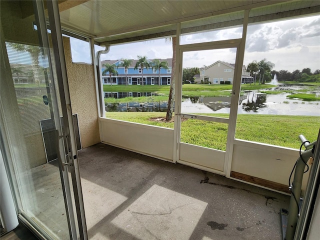 unfurnished sunroom with a water view and a wealth of natural light