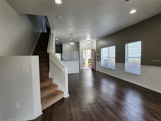 entrance foyer with dark wood-type flooring and a chandelier